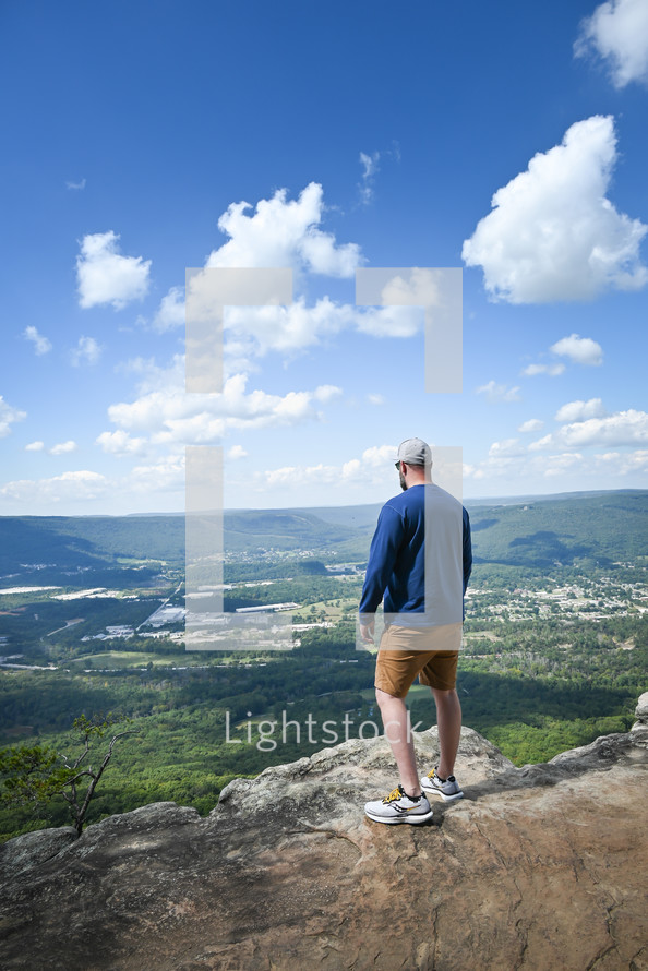a man looking out over a valley