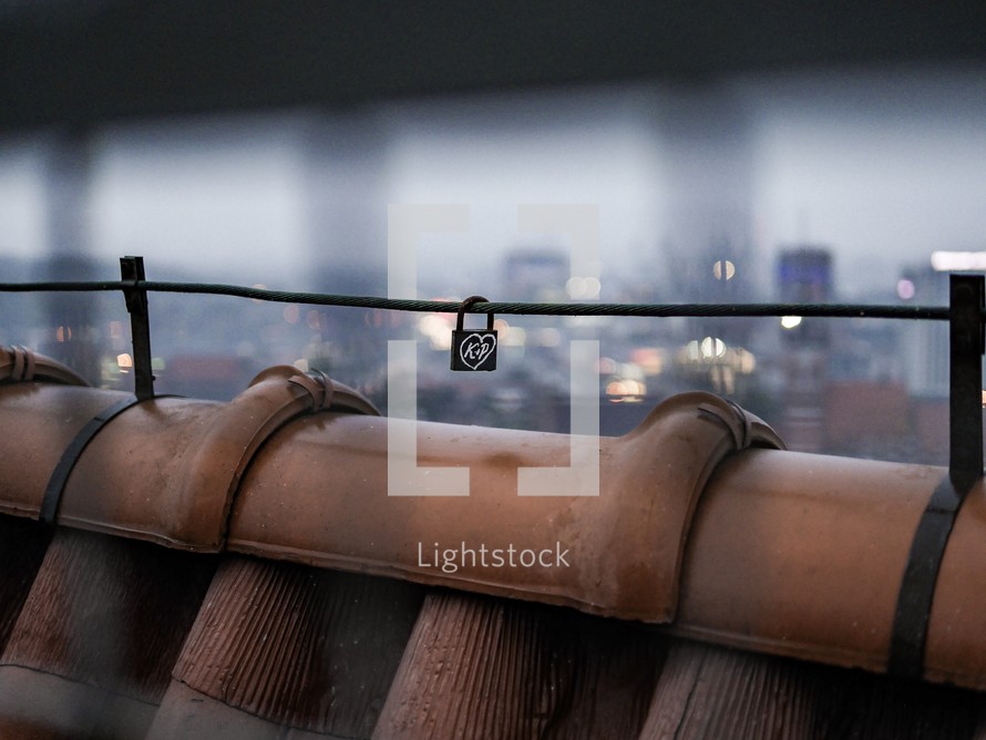 love lock on a rooftop railing 