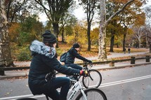 couple riding bikes in a park 
