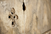 A cross carved onto a piece of wood