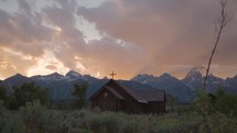 Old Wooden Chapel in the Mountains at Sunset