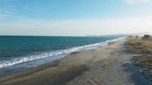 Ocean Waves Of Italian Sandy Beach During Cold Winter