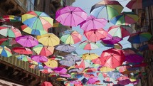Historic Street of Catania adorned with colorful Umbrellas 