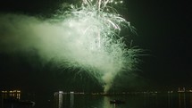 Tilt up of fireworks show off barge on Independence Day