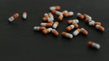 falling pills on black slate table