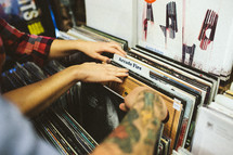 a couple looking through records at a record store 