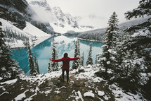 person standing on a rock in front of Moraine Lake 