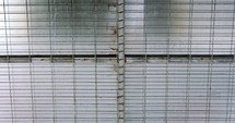 Abstract textures and patterns- grey metal grid door with metal plates