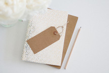 blank gift tag on a stack go journals 