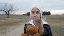 Sad depressed girl with teddy bear, punishment. Childhood. Education. Problem. Sad little girl and her teddy bear. Sad little girl feels lonely.