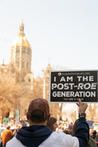 Man holding sign at pro-life rally