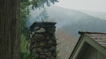 Cabin chimney expels smoke during winter 