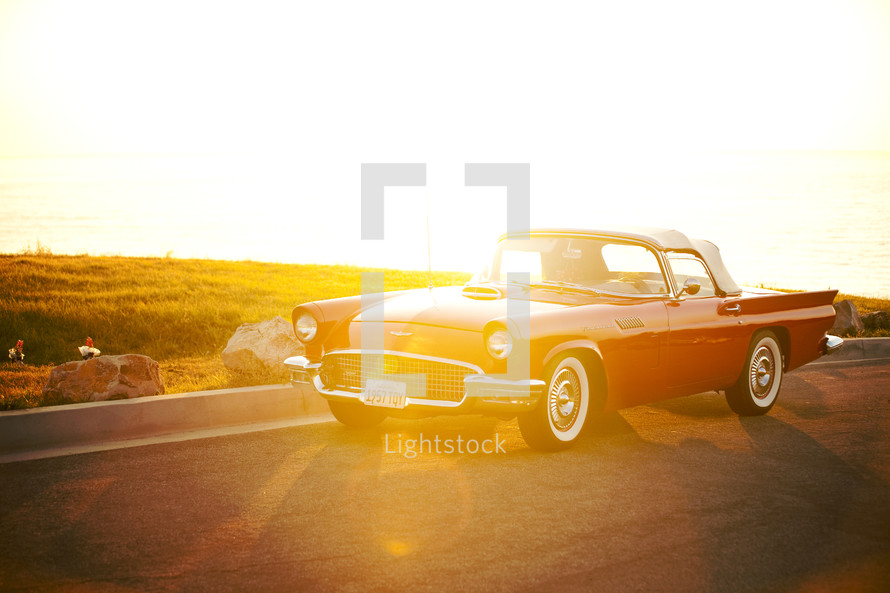 vintage Thunderbird on highway - sunburst on car