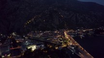 Night aerial view of Kotor, Montenegro, with illuminated streets and bay