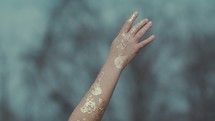 gold glitter on a reaching arm 