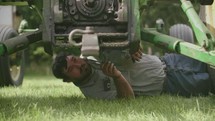 a farmer working on a tractor 