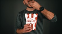 a man eating popcorn 