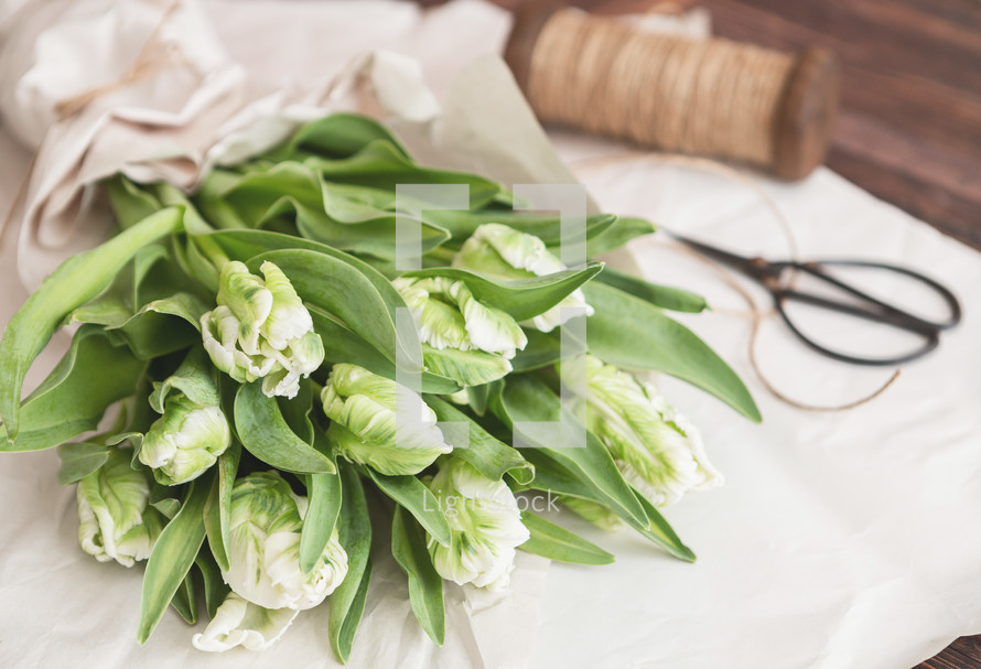 Bouquet of green leaves with white blossoms