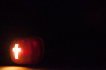 cross carved in a Jack-O-Lantern pumpkin 