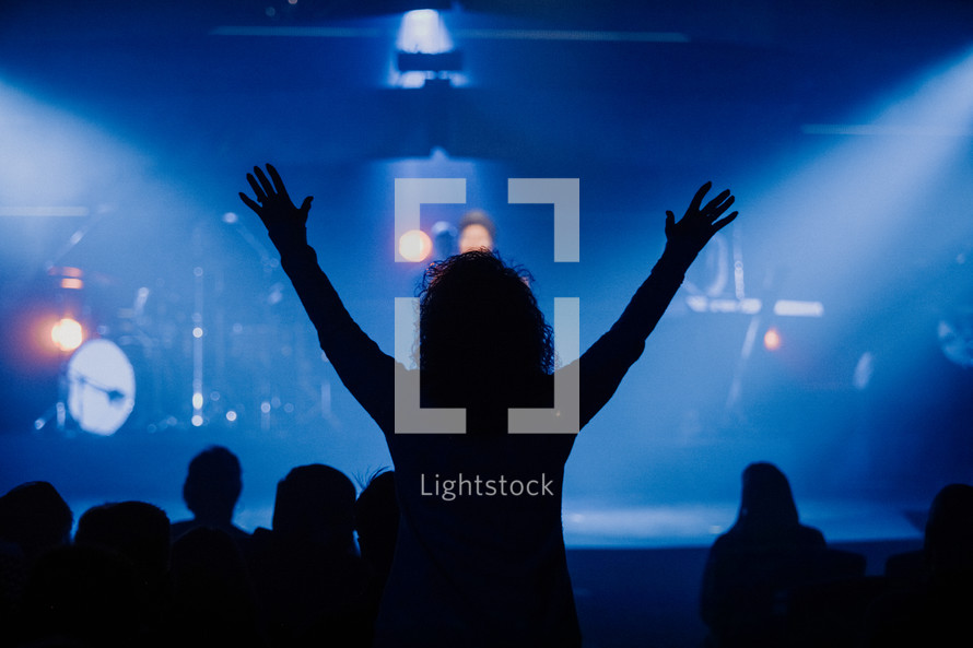 Woman with raised hands in worship