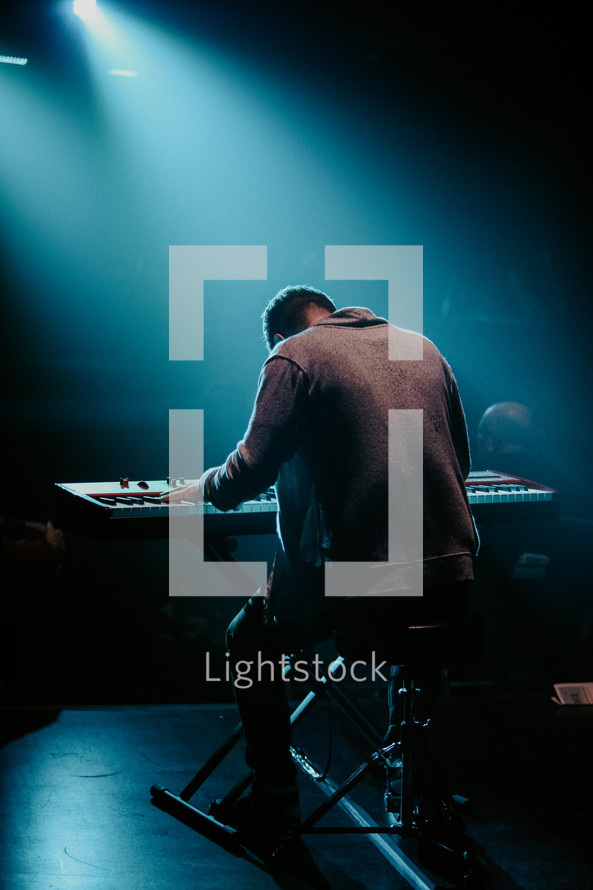 Man playing keyboard in worship setting