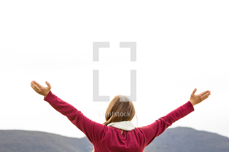 girl with hands raised high 