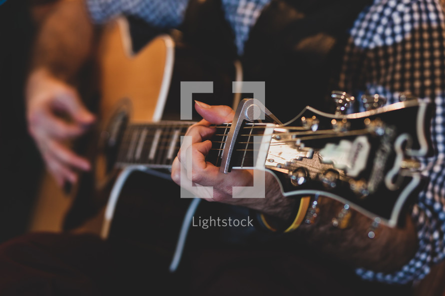 man's hands playing classic guitar. Selective focus.