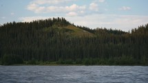 Forested Hills Across A River