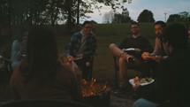 friends sitting around a fire 