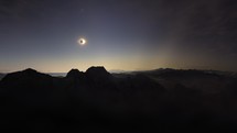 Hyperlapse above mountains at solar eclipse totality moment	