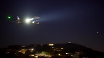 KERKYRA, GREECE - October 28, 2021: Close up footage of passenger plane landing above night sea, lights and dark.