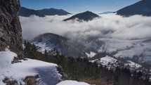 Low clouds holding in a snowy valley in winter frosty time, zoom in,timelapse video misty landscape