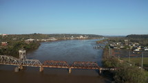 Aerial View of the Arkansas River in Little Rock, Arkansas. Drone view flying over railroad bridge near downtown Little Rock.