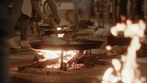 Slow-motion of Paella cooking over open flame in Valencia, Spain
