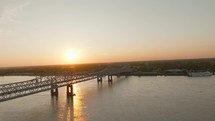 Drone Video of Sunset Over Bridge in Natchez Mississippi on the Mississippi River. High quality 4k footage