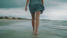 woman walking in the tide 