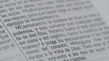 Close up of a page in a Spanish translation Bible.