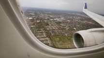 Airline passenger POV while inbound for landing at a city airport