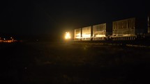 Two freight trains passing each other at night