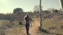 woman walking on a trail in a park 