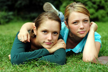 teen girls reading a Bible outdoors 
