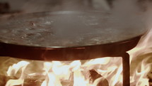 A large paella dish with boiling chicken stew - Valencia Las Fallas Celebration