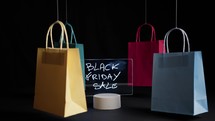 Shopping bags moving with Black Friday advertising 