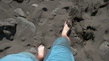 feet walking on a beach 