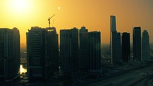 Silhouette Of A Town Skyscraper With Construction Towers And Cranes