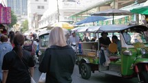 tuk tuks crowd through narrow streets in bangkok