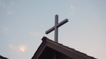 Cross against a partly cloudy sky