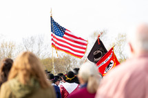 American flag and military flags at outdoor event
