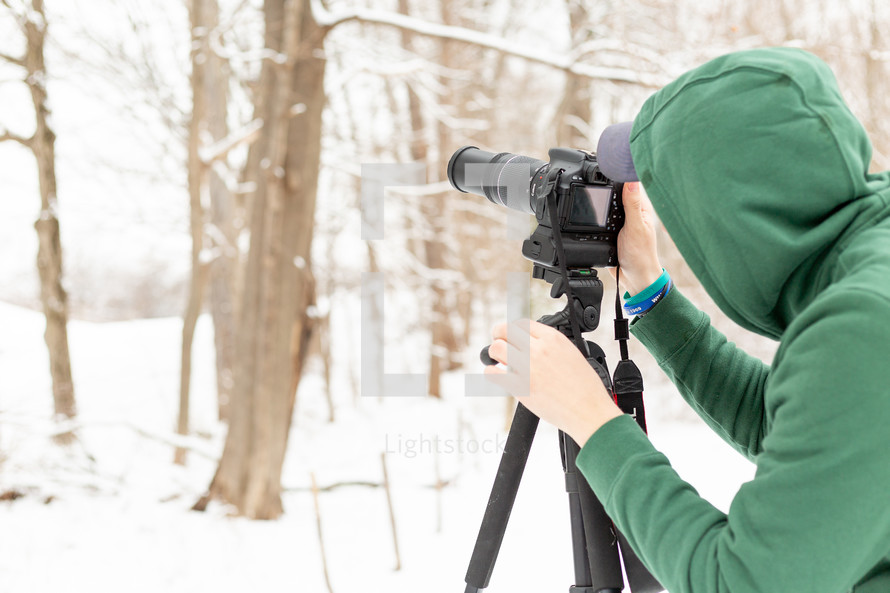 Photographer in snowy forest