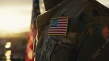 American flag on chest of military man praying for memorial day